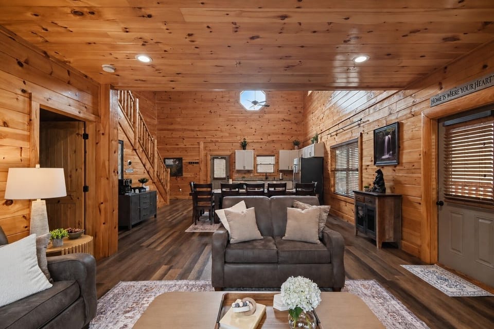 Warm wood cabin interior with cozy seating and open-concept living