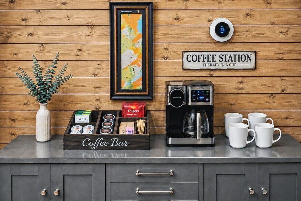 Cozy coffee bar with stocked beverage station and warm rustic charm
