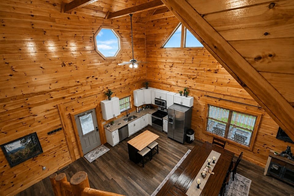 Rustic open-concept cabin kitchen with vaulted wood ceilings