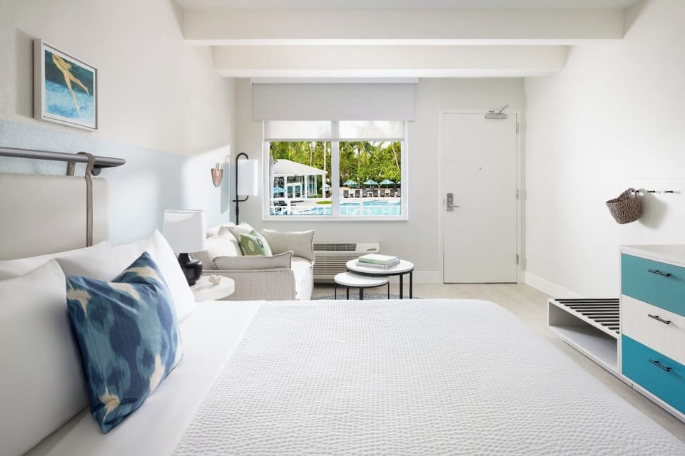 Lounge by the window while resort scenery shimmers outside.