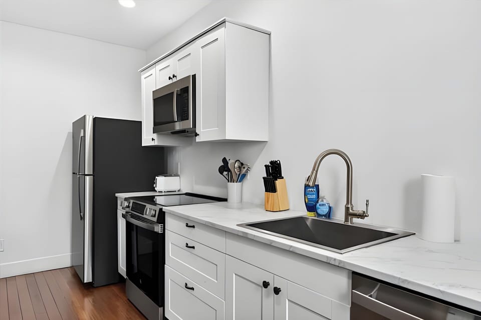 Whip up your favorite green recipes on the pristine stainless steel electric stove. The modern microwave above it is great for heating up quick snacks.