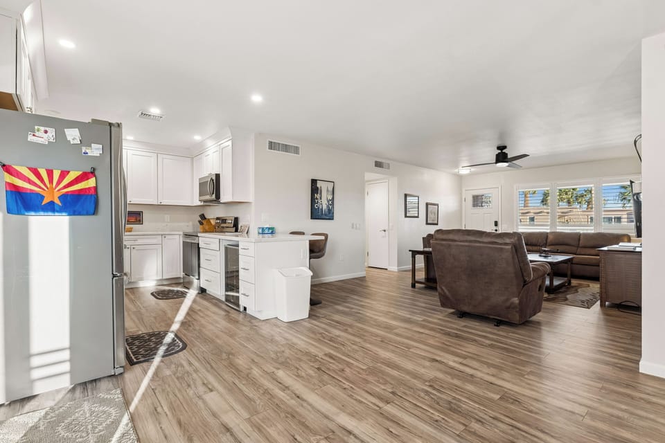 Stainless steel appliances, wine fridge, counter seating for 2, and cooking essentials.