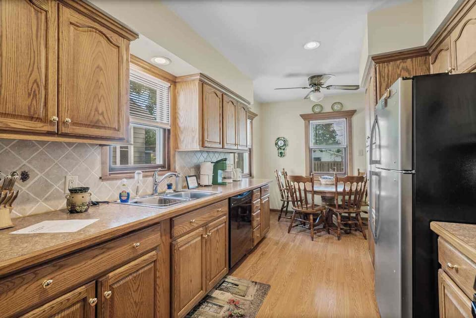 Recently renovated kitchen with appliances, coffee makers, and dishes. 