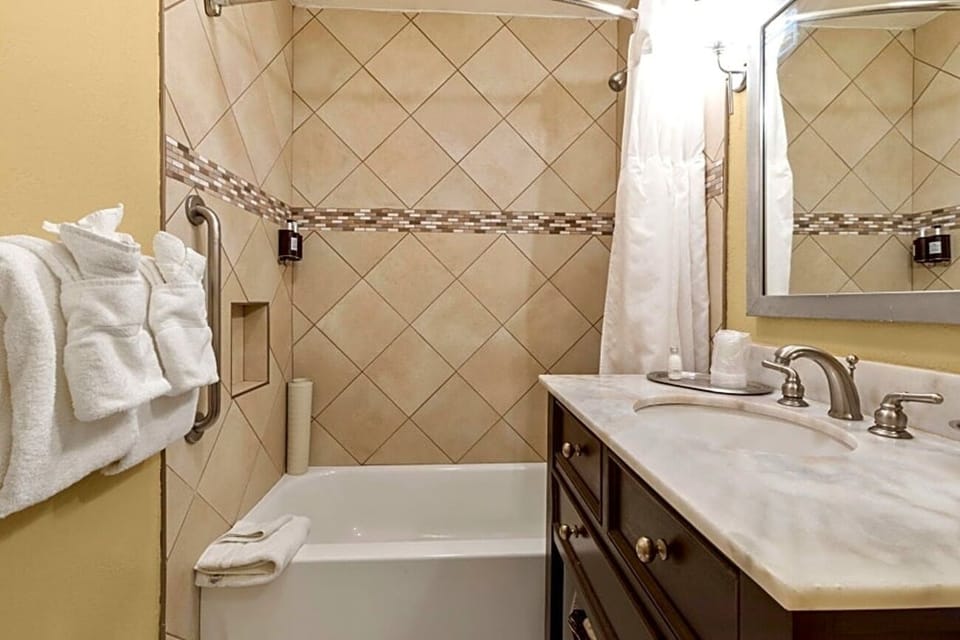 Refresh with fluffy towels and a spotless shower-tub combo.