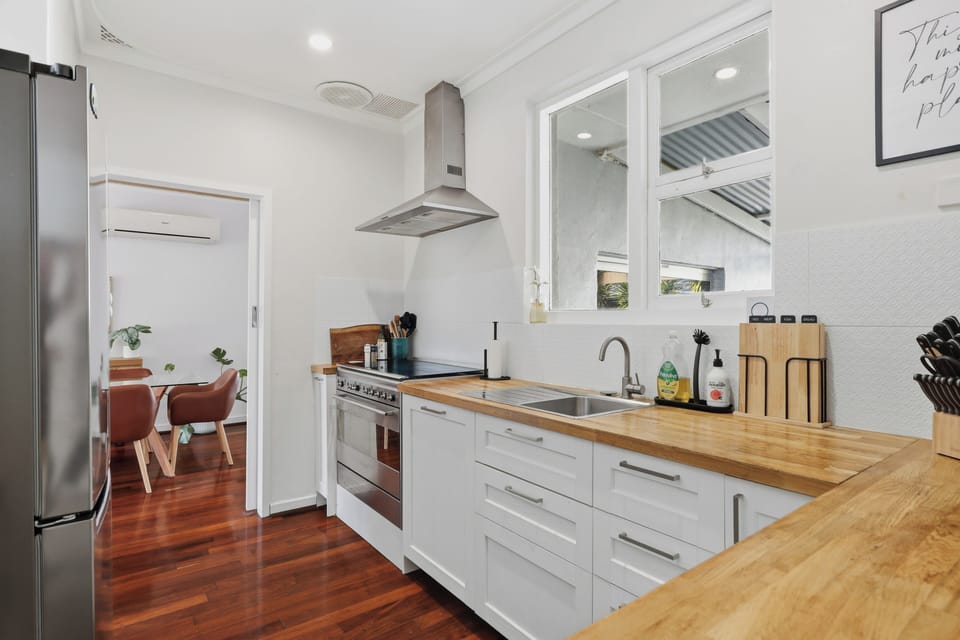 Cook up a feast in style with timber countertops, sleek stainless steel appliances, and a seamless flow into the dining area!