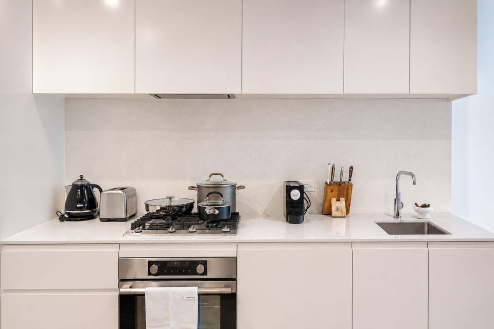 Bright modern kitchen with sleek finishes and full cooking essentials
