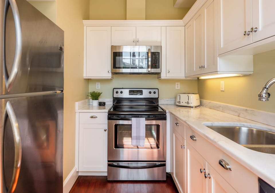 Modern kitchen with dishwasher, ample storage, and drip & pod coffee options.