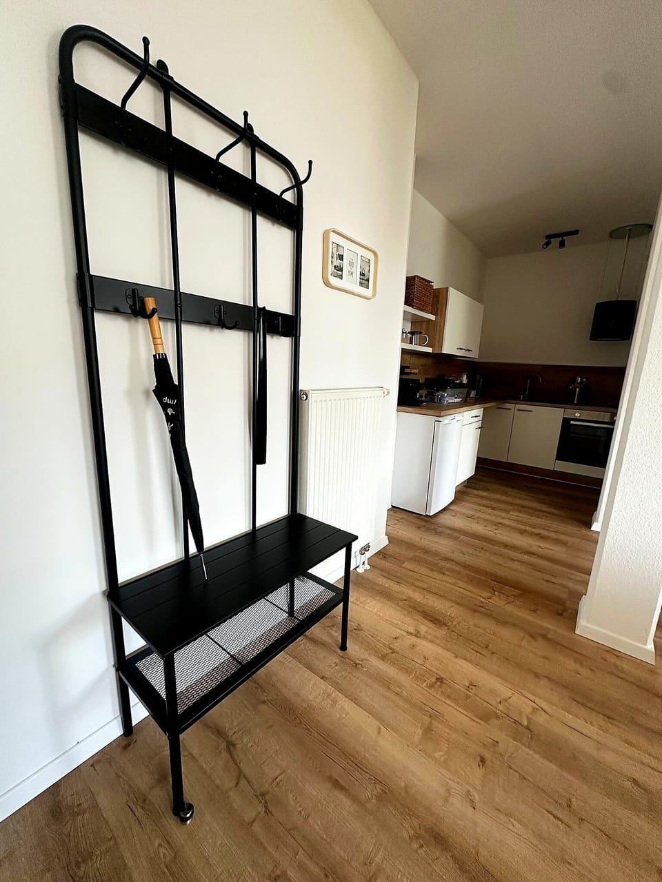 Bright entryway with bench seating and easy access to the modern kitchen