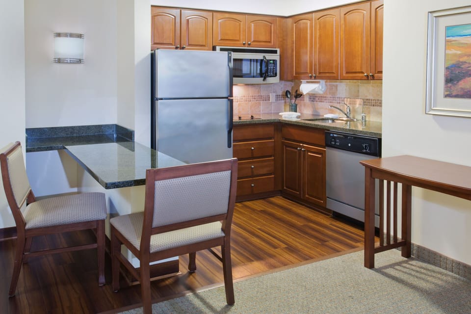 Well-equipped kitchen with modern appliances and dining space.