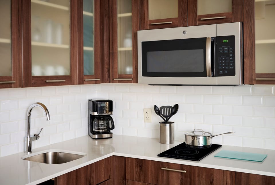 Kitchen with wood cabinets, microwave, and coffee maker.