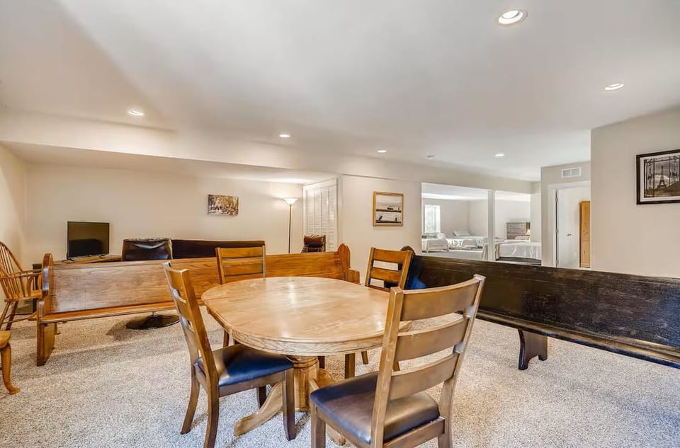 Dining table separated from sleeping and social areas. Plenty of extra seating.