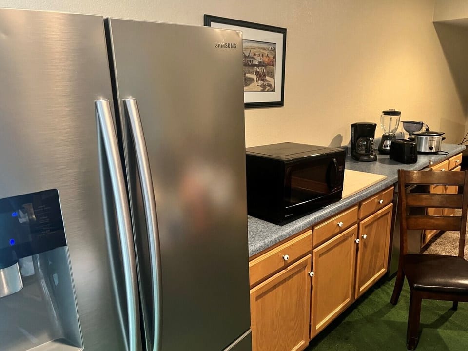 Dining area with fridge microwave crockpot coffee blender + nearby utility sink,