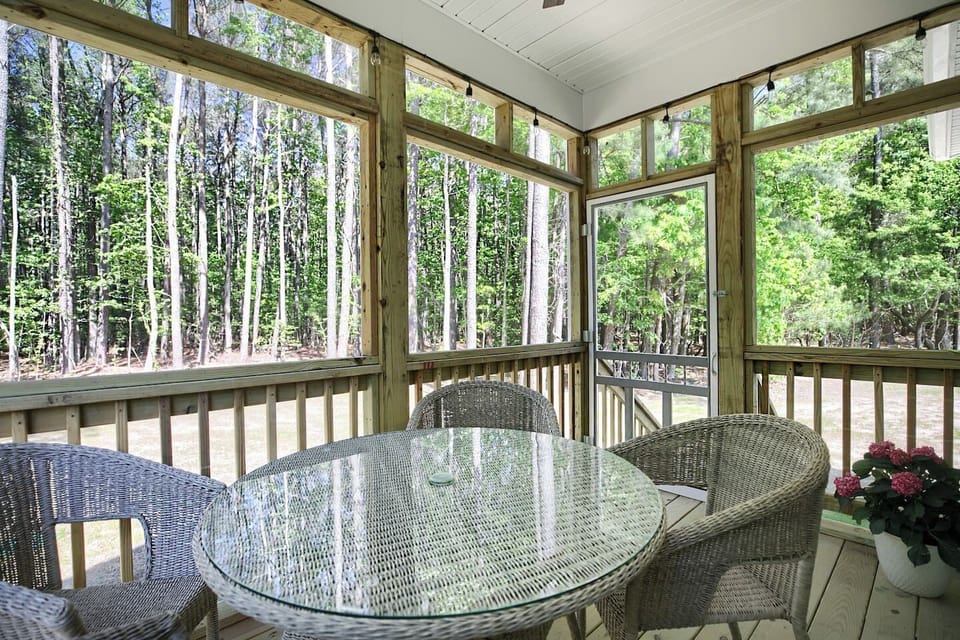 Screen porch overlooking the back yard. 