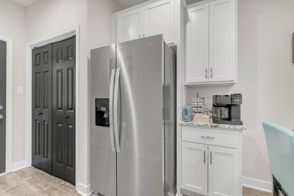 Fully stocked coffee bar with a Keurig, K-Cups, ground coffee, creamer, and sweeteners provided.