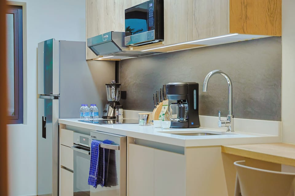 Your fully equipped kitchen has everything you need—sleek countertops, a microwave, coffee maker, blender, and modern appliances ready to help you prepare meals just the way you like them.