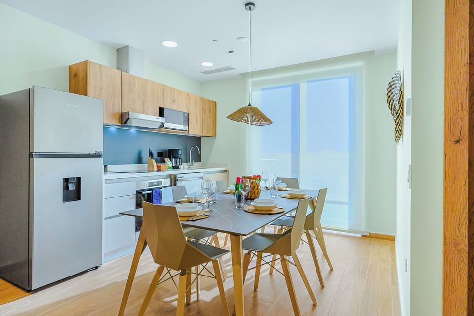 Gather around your modern dining table in this bright, open-concept kitchen and dining space designed for shared meals and conversation.