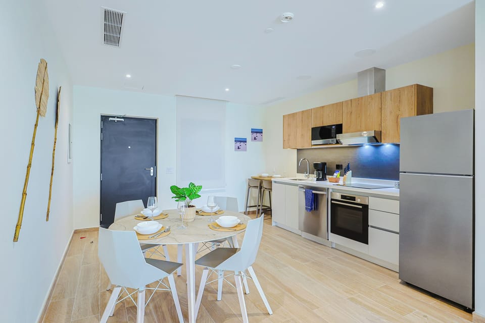 Gather around the dining table or whip up your favorite meals in a fully equipped kitchen with modern appliances and sleek cabinetry. Everything you need for a comfortable stay is right here at your fingertips.