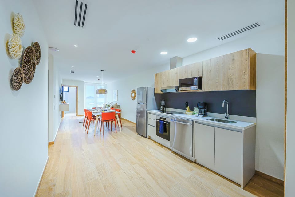 Your fully equipped kitchen invites easy meal preparation, with sleek countertops and modern appliances ready for your culinary adventures. The bright, open layout flows into the dining area, creating a warm space for gathering.