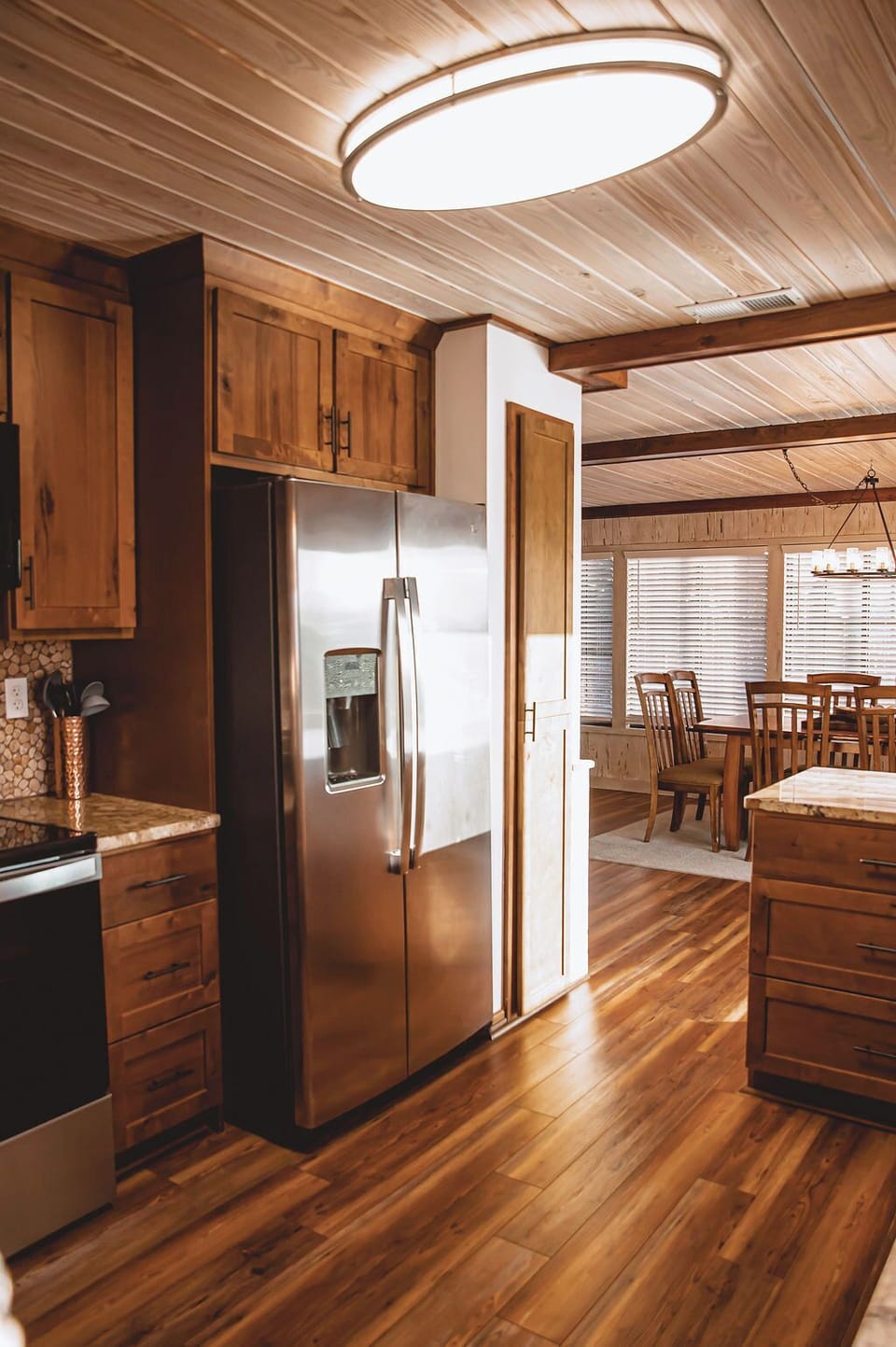 Rustic wood kitchen with stainless appliances and bright dining space