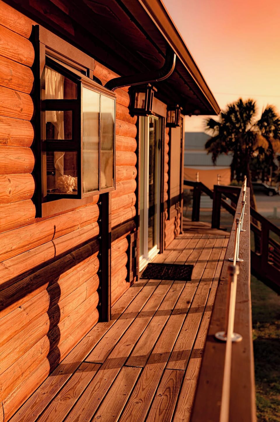 Sunset-lit cabin deck with rustic charm and a scenic coastal feel