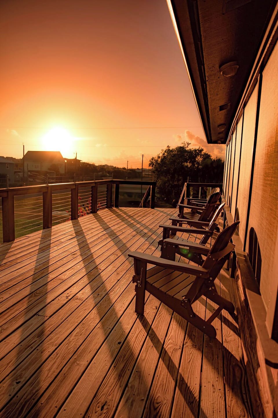 Spacious sunset deck with Adirondack chairs and peaceful open views