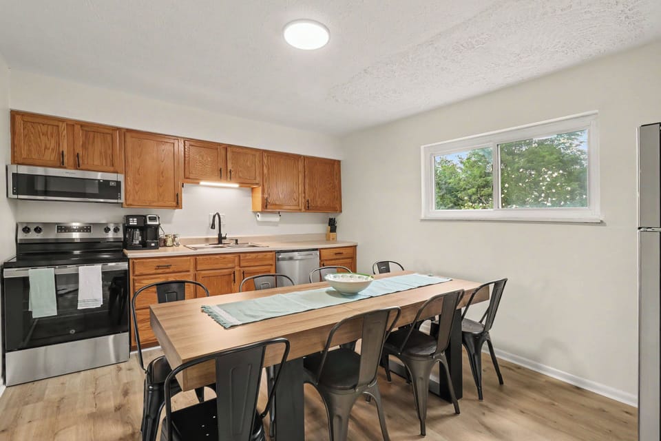 Fully equipped kitchen with dining table, coffee maker and cooking essentials 