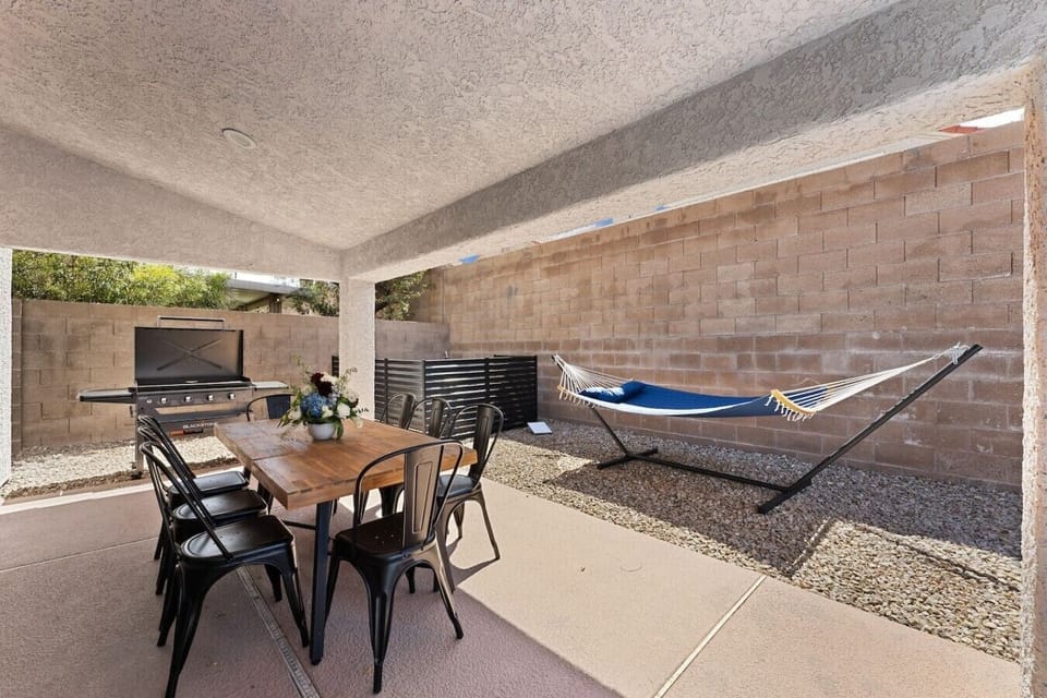 Covered patio with outdoor dining a BBQ grill and hammock