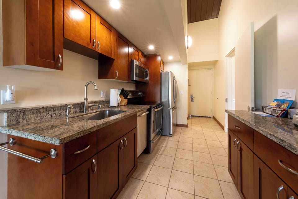Prep island-style with granite counters and handy cookware setup.