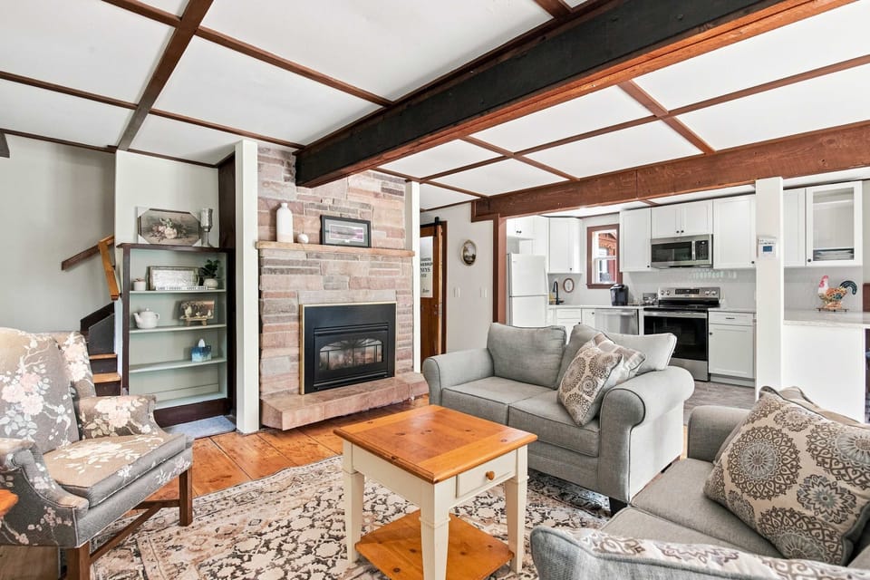 Open-concept main level where the living area, with its gas fireplace and comfortable seating, flows right into the kitchen.