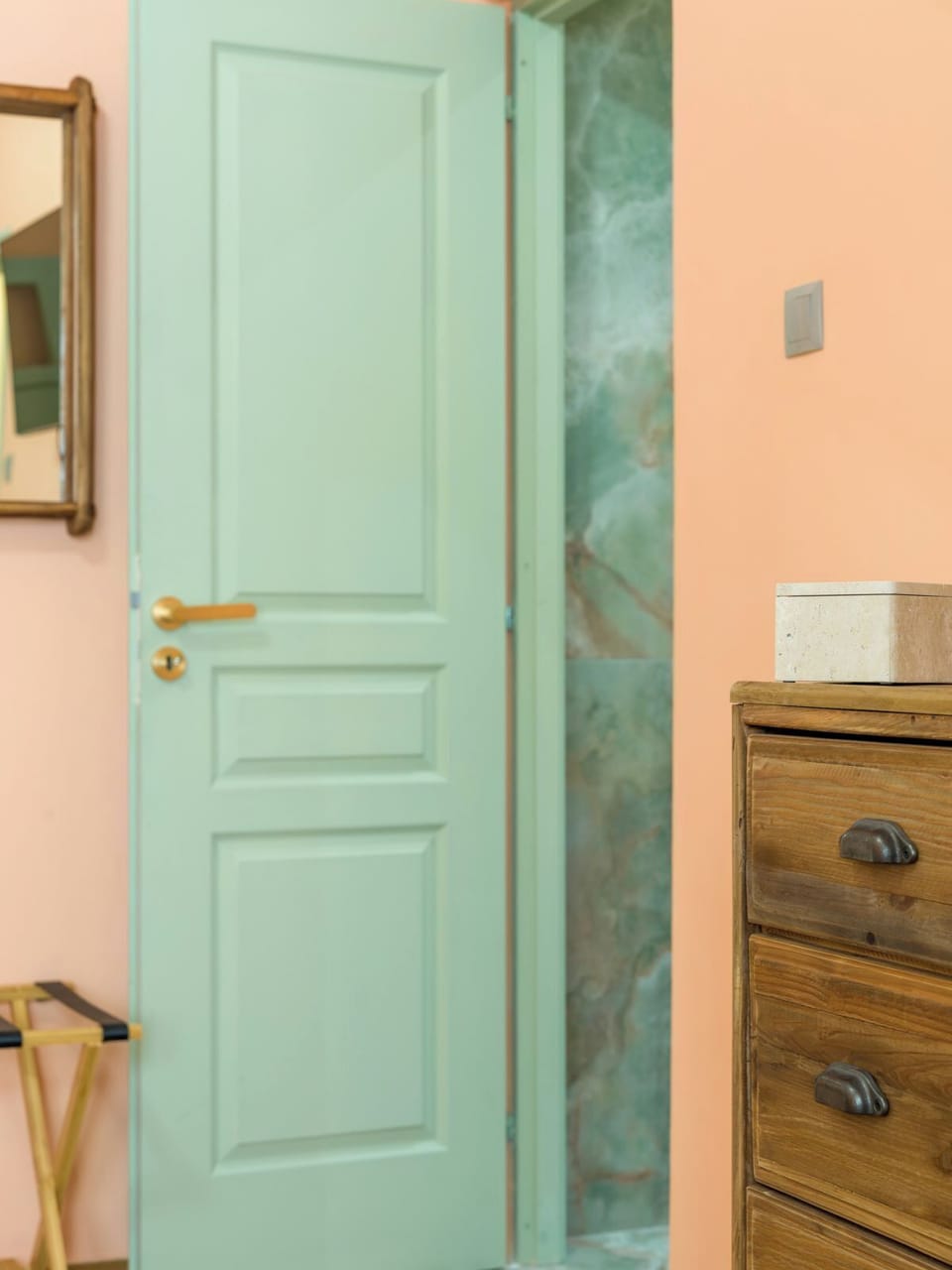 A glimpse towards the ensuite, framed by soft colour and warm details