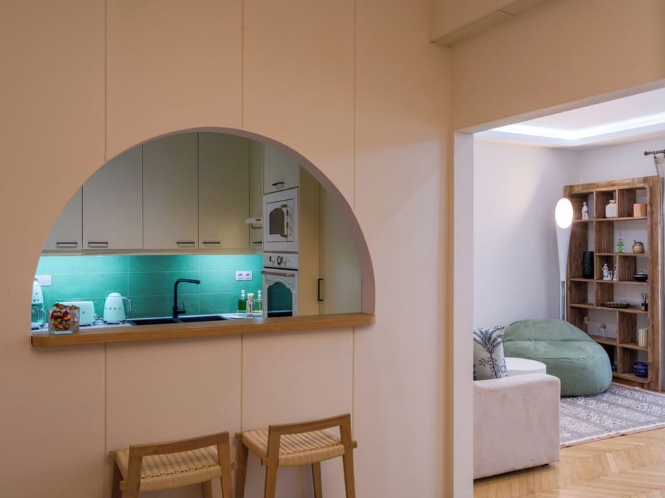 The kitchen opens through its archway to the second lounge