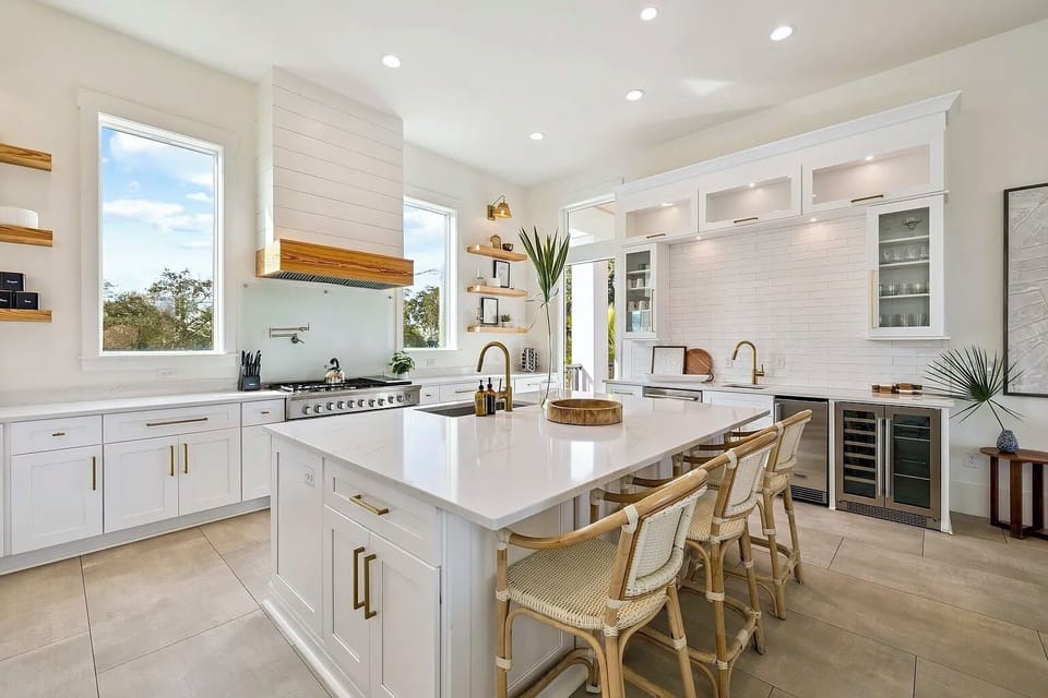 Open kitchen layout with dual dishwashers, double wine fridges, and ample quartz prep space.