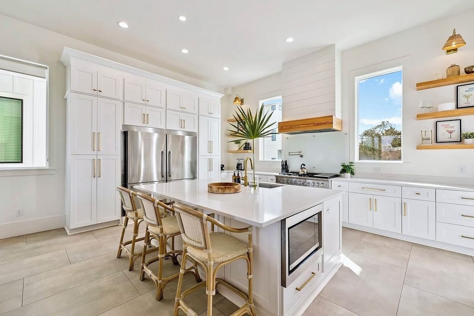Chef’s kitchen equipped with professional Wolf gas range, custom shiplap hood, and Sub-Zero refrigerator.