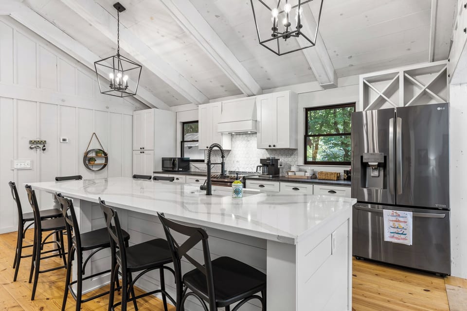 The spacious kitchen island offers plenty of room for cooking, serving, and gathering together.
