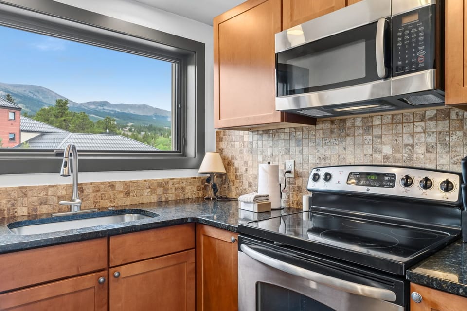 Cook up your favorite meals with mountain views as your backdrop. A fully-equipped kitchen with stainless appliances and granite countertops makes meal prep effortless.