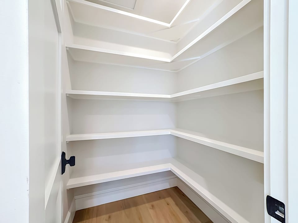 Store all your belongings easily in this spacious walk-in closet with wraparound shelving on multiple levels, giving you plenty of organized storage throughout your stay.