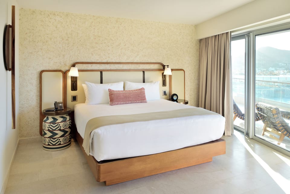 Wake up to sunlit comfort beside your private balcony.