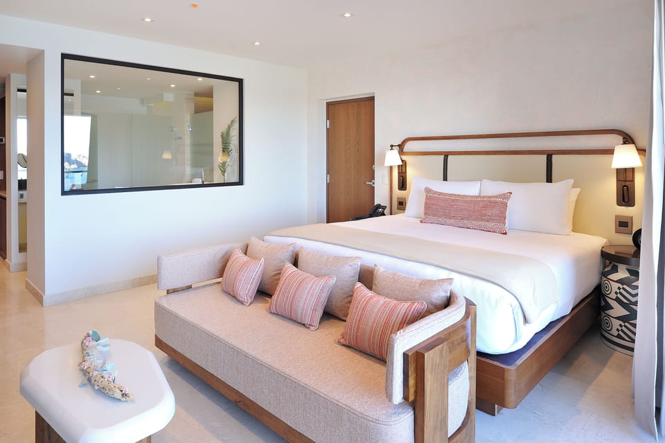 Unwind in a serene king suite with lounge sofa.
