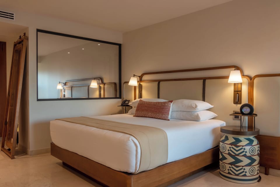 Sink into a plush bed framed by calming, modern tones.