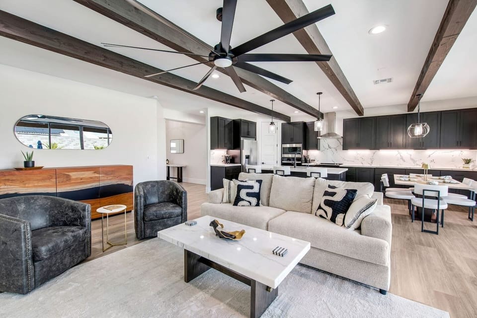 Open-concept layout connecting the cozy living room with the modern, fully equipped kitchen.