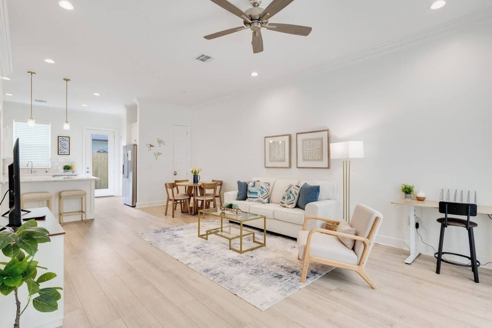 Open living room, dining room, kitchen, and desk area. 