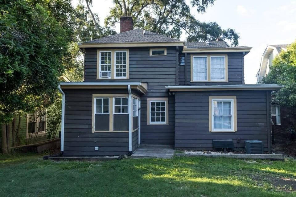 Private backyard retreat with shaded lawn and charming rear exterior