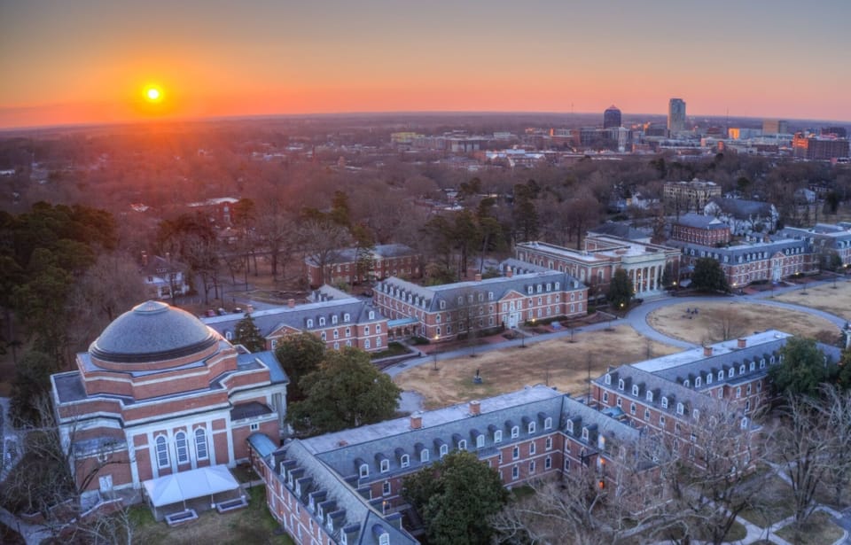 Stunning sunset aerial with historic brick architecture and skyline views