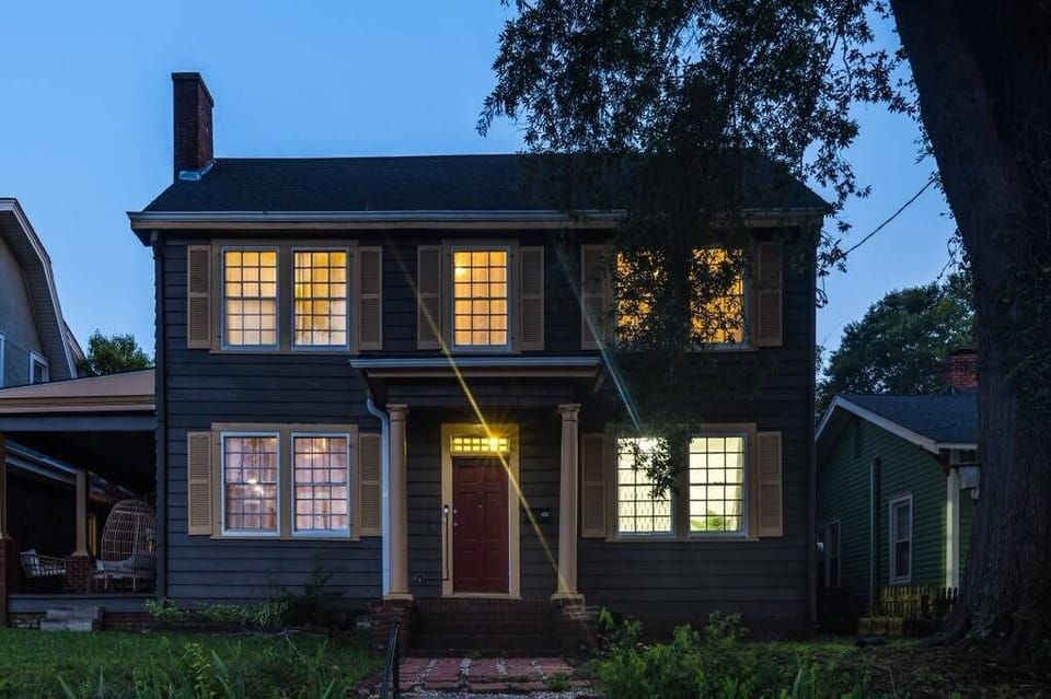 Charming dusk exterior with glowing windows and inviting curb appeal
