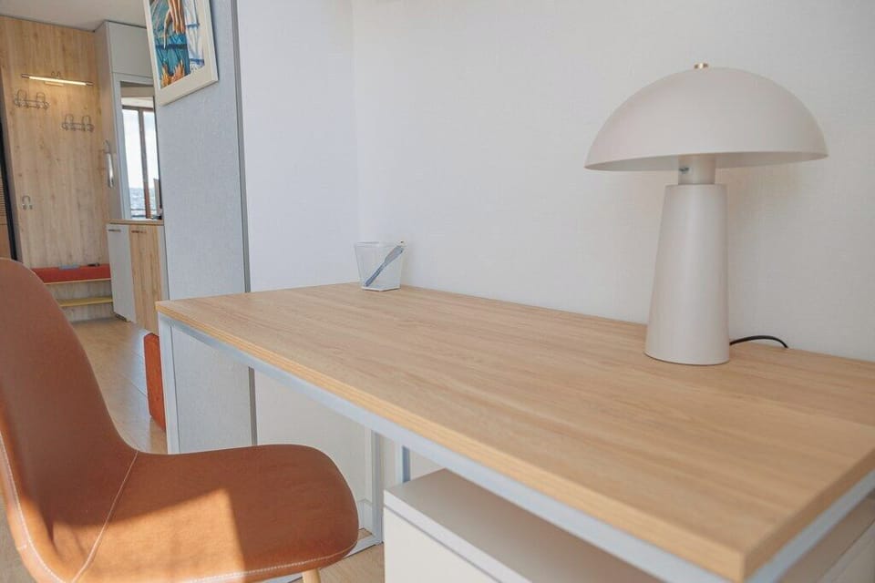 Dedicated workspace with a desk, comfortable chair and task lamp.
