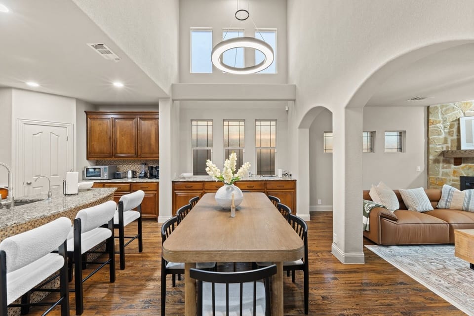 Gather around the dining table for shared dinners, with the kitchen, island seating, and living room all flowing together for easy everyday living.