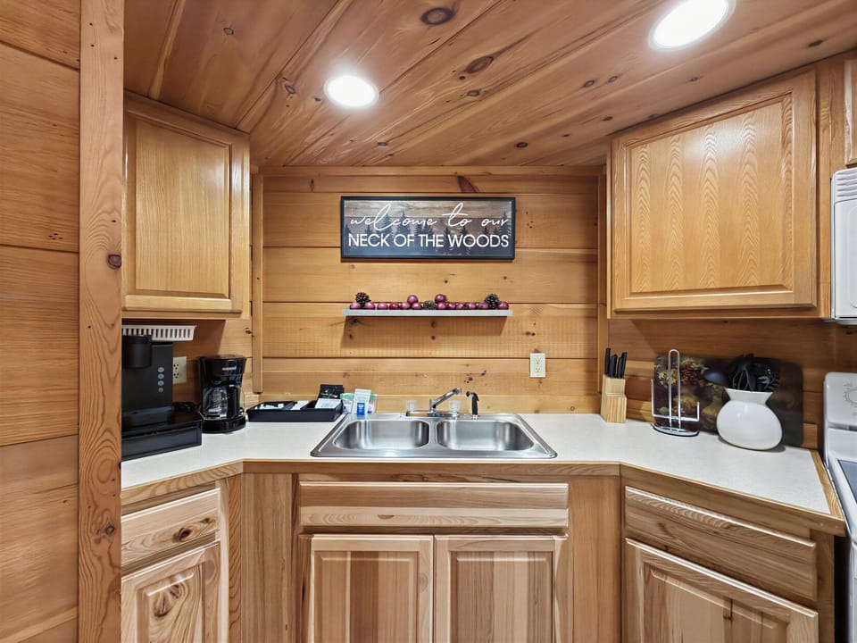 Cozy wood-paneled kitchenette with coffee station and rustic charm