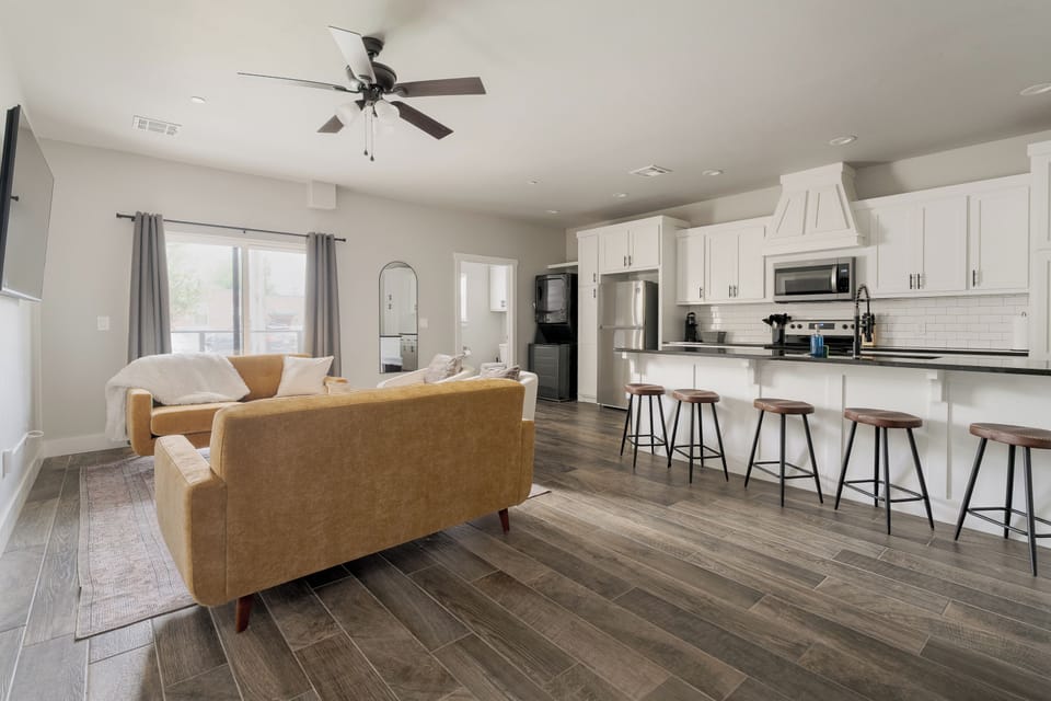 Bright open living space with modern kitchen and breakfast bar seating