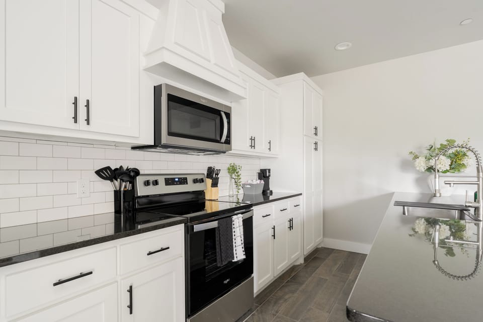 Bright modern kitchen with island, stainless appliances, and ample storage