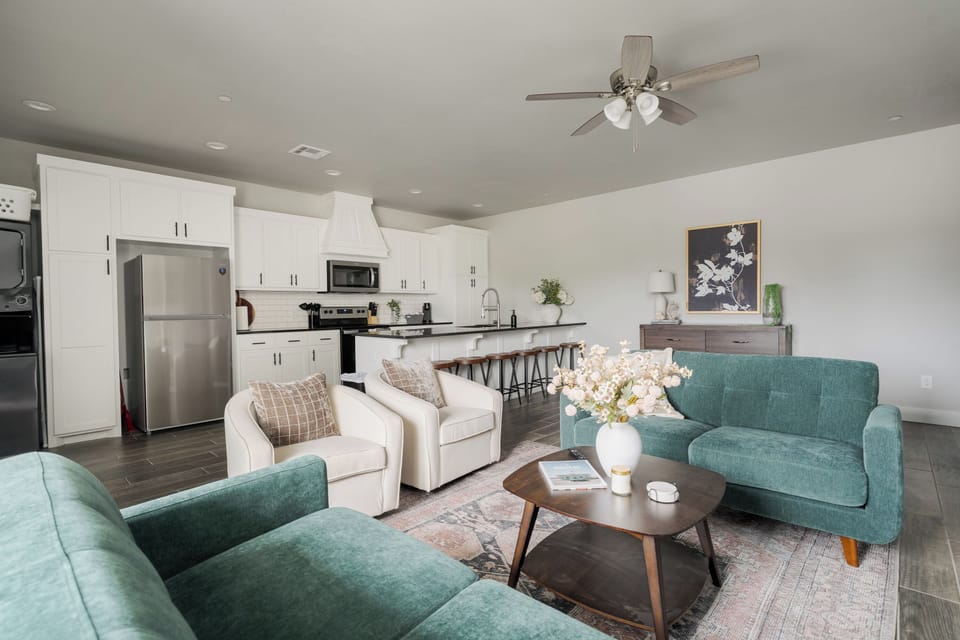 Bright open living room with stylish seating and modern kitchen bar
